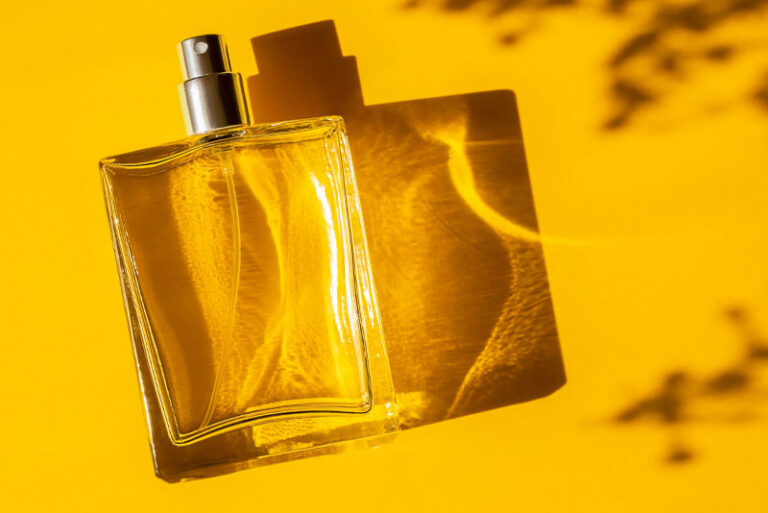 Fragrance bottle lay on yellow background with anodised cap