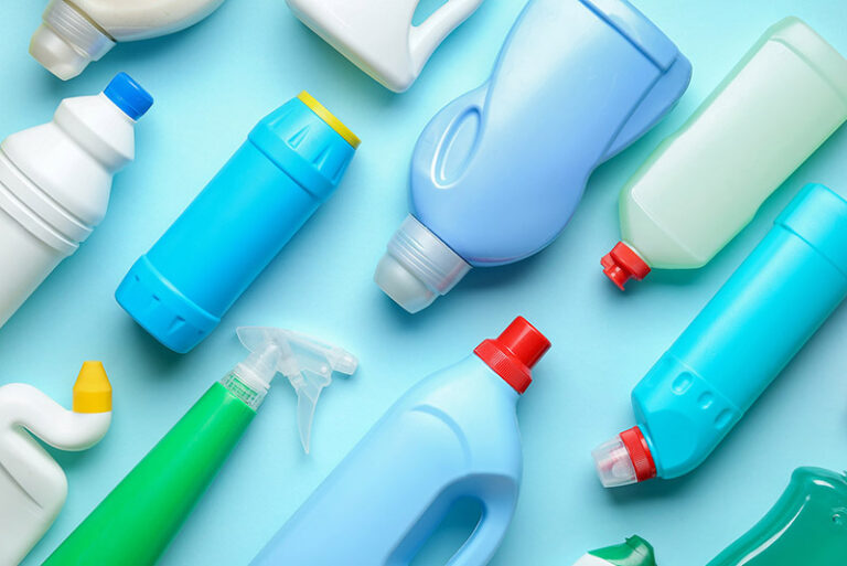 Blow moulded plastic household products bottles group on blue background