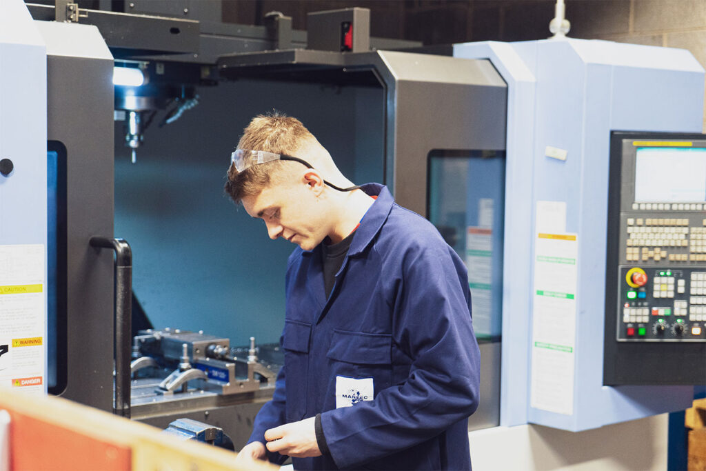 Apprentice at a CNC Machine